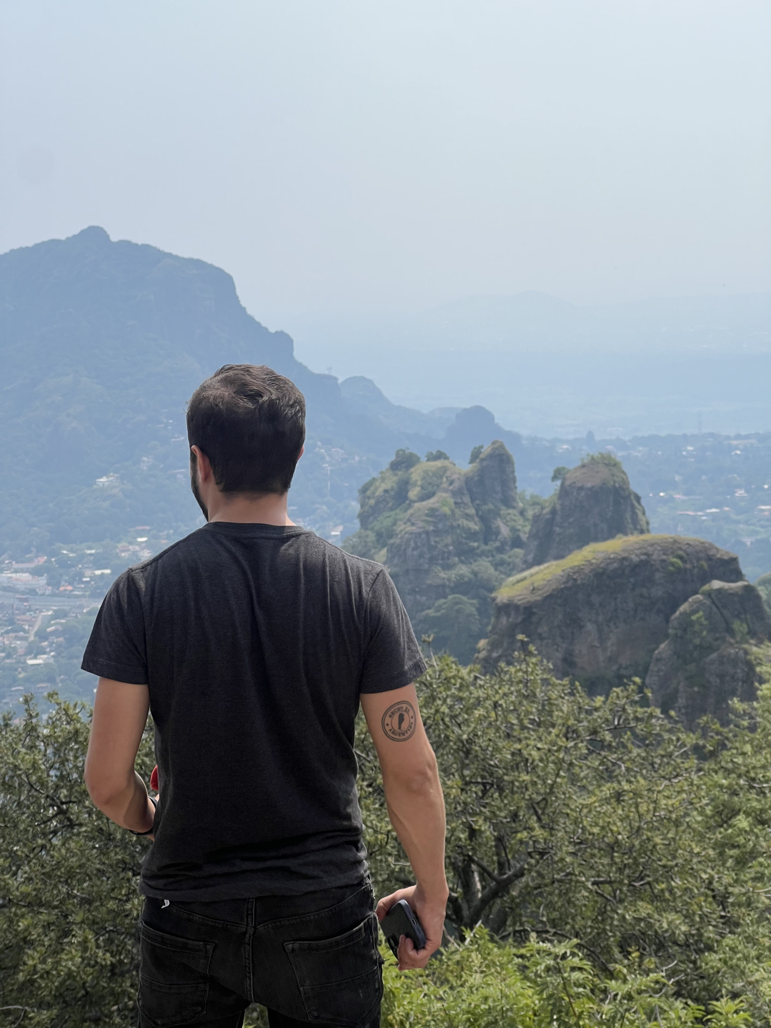 Tourist overlooking the lush valley and Tepozteco mountains, a scenic stop included in all premium Tepoztlan tours.