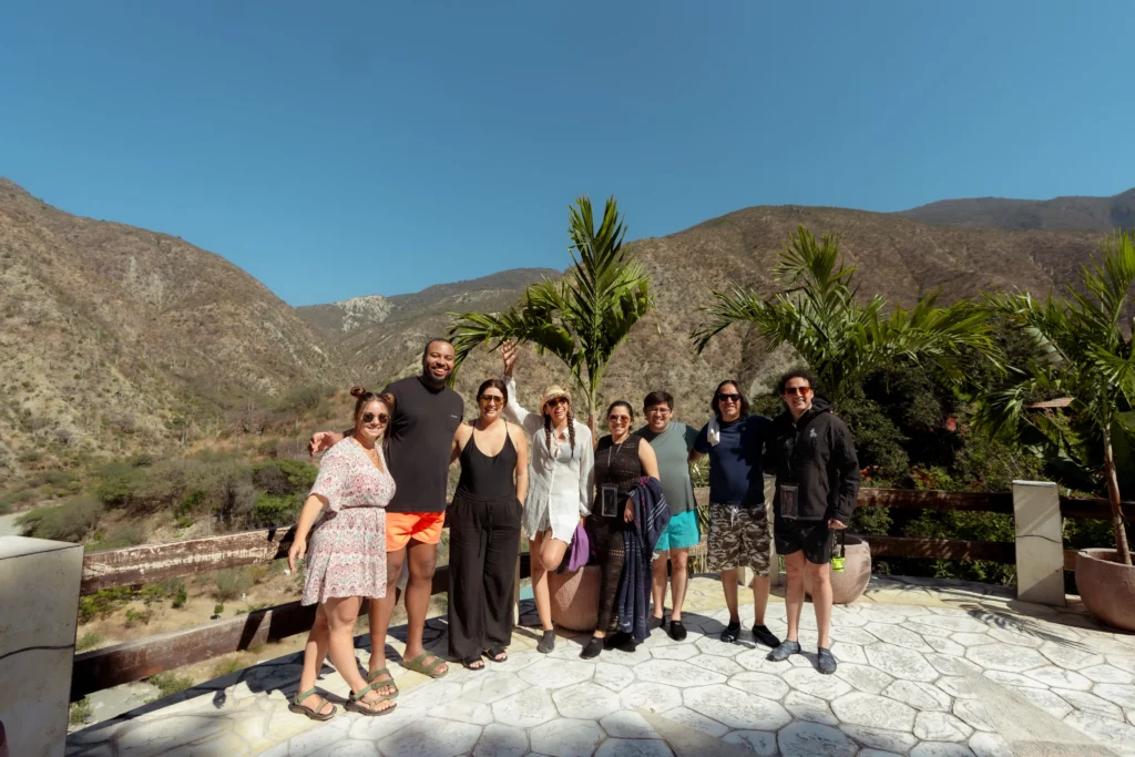 A diverse group of friends smiling on a terrace in Tolantongo, enjoying unique experiences in Mexico City and beyond.