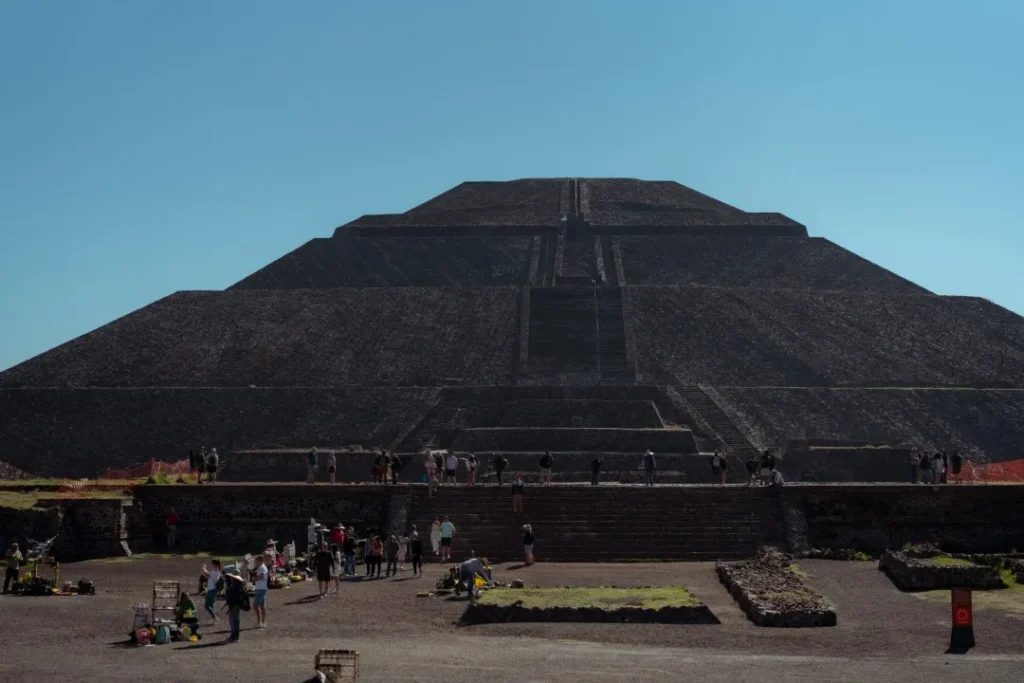 How to visit Teotihuacan without the crowds: tourists gather at the base of the massive Pyramid of the Sun.