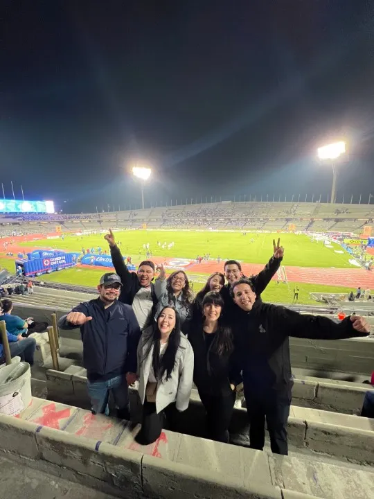 Group of friends at a soccer stadium. Is Mexico City safe for tourists in 2026? Yes, sporting events are vibrant.