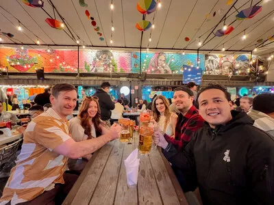 Friends raise a toast during The Michelada Workshop Experience in Mexico City, a unique beer class.