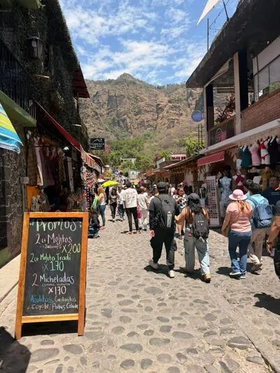 A busy town market street with a promo menu board on the way to the scenic Tolantongo Hot Springs in Mexico.