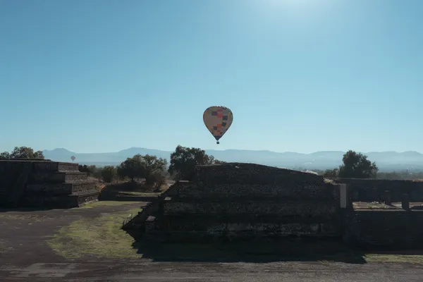 Panoramic scenery of the ancient archaeological site and mountains during a sunrise hot air balloon ride over Teotihuacán